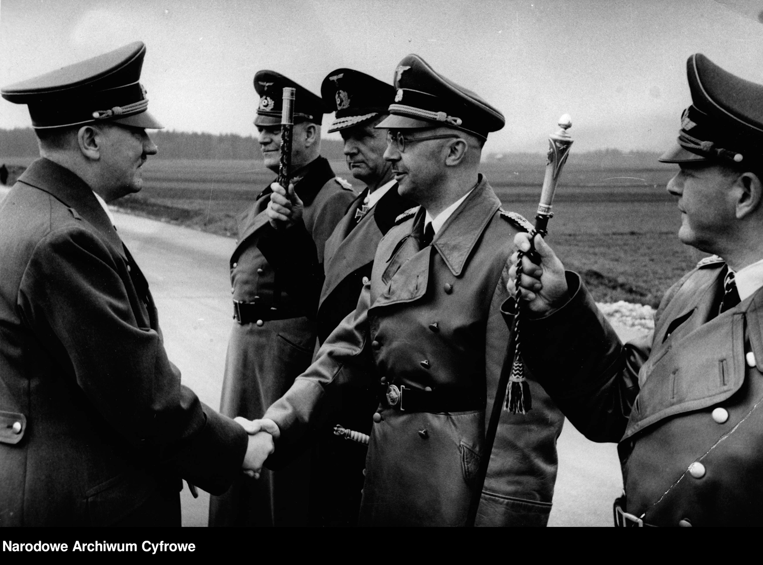 Adolf Hitler greets Heinrich Himmler on the day on his 55th birthday, near Schloss Klessheim